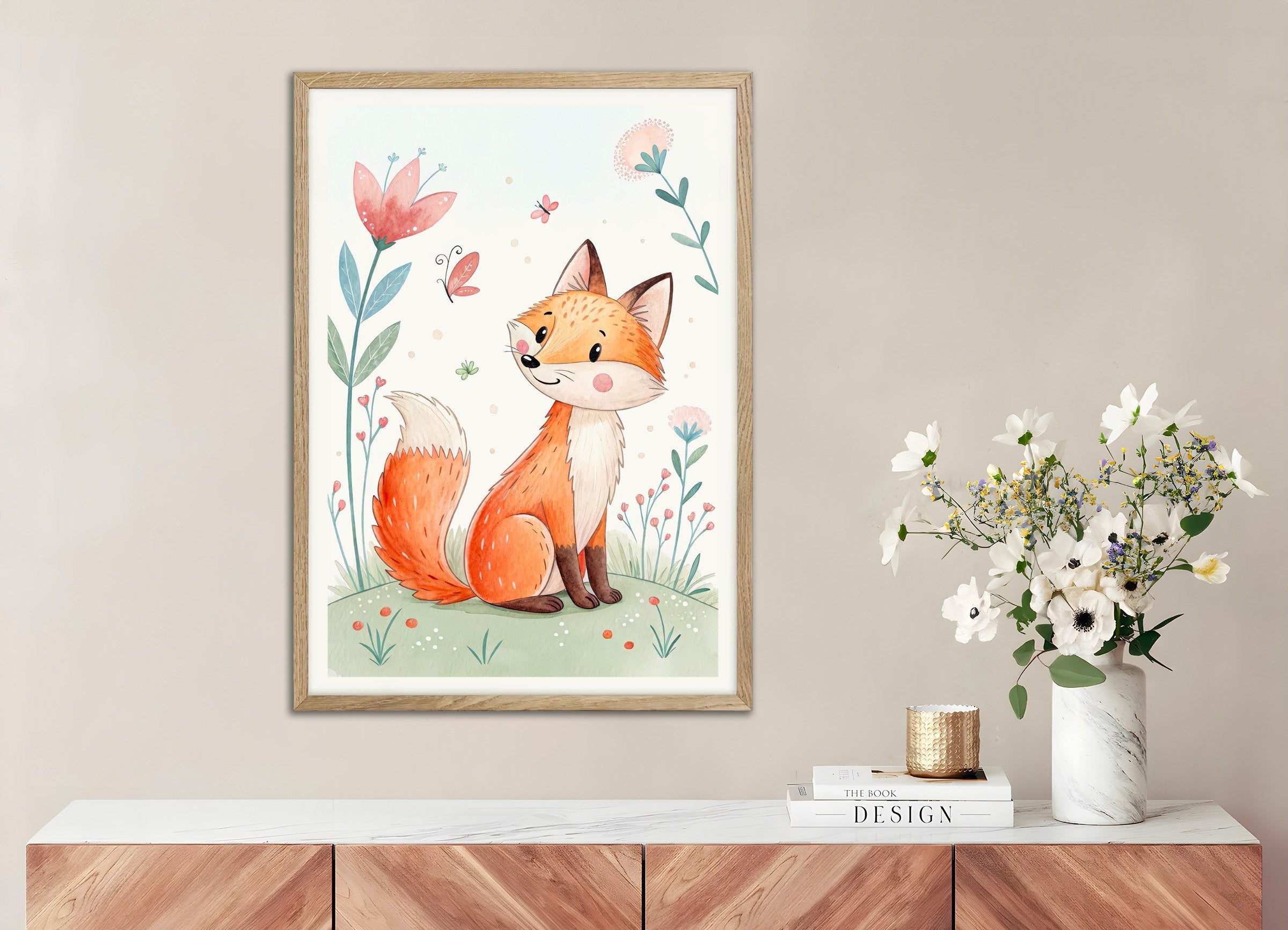 Framed illustration of a fox on a wall above a wooden cabinet with a vase of flowers.